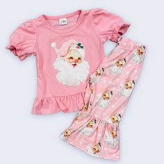 2pc Boutique Christmas Outfit Features Embroidered Santa On Short Sleeve Pink Top And Pink Santa Print Bell Style Pants. Christmas Cotton Sets For Festive Occasion, Cute Pink Holiday Sets, Cotton Festive Holiday Sets, Playful Cotton Sets For Holiday, Playful Pink Sets For Holiday, Playful Pink Holiday Sets, Cute Fitted Christmas Sets, Cute Cotton Holiday Sets, Cute Cotton Sets For Holidays