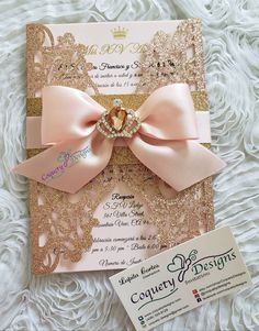 a pink and gold wedding card with a large bow