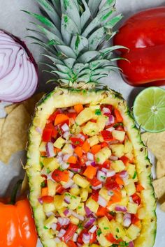 pineapple salsa in a pineapple cut in half and served with tortilla chips