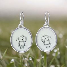 Puppies are a beautiful thing. These sterling silver dangle earrings measure 1 and 1/4 inch tall with the drop and 3/4 of an inch wide. They are made with 4 coats of kiln fired vitreous enamel for a waterproof, durable and vibrant finish.I ship these in a gift box, First Class Mail with tracking. White Enamel Earrings For Gift, Enamel Teardrop Jewelry With Matching Earrings, Teardrop Enamel Earrings For Gifts, Silver Enamel Drop Earrings, Nickel-free Enamel Drop Earrings, Cat Memorial Jewelry, Vitreous Enamel, Dog Earrings, Dog Jewelry