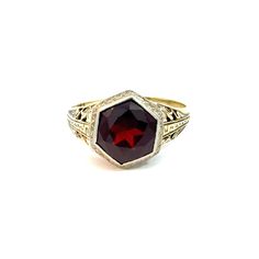 Art Deco garnet doublet ring in 14k white and yellow gold.  This stunning ring features a Greek key pattern down the shoulders and scrolling filigree throughout.   The hexagonal garnet and glass doublet is a rich red hue and surrounded by a white gold bezel. This ring is in very good vintage condition with some abrasion to the garnet doublet.   The Details: Ring size - size 6.75, sizeable Metal type - 14k white and yellow gold (stamped and tested)  Ring weight - 2.8 grams total Gem type - Garnet Glass Doublet Gem dimensions - 9.00 x 9.00 mm Gem cut - Hexagonal Faceted This ring has been inspected by a GIA Graduate Gemologist independent of Treanor House to provide an unbiased opinion of this piece.  To view the shop policies, including returns and shipping, please visit:  https://www.etsy. Elegant Red Intaglio Signet Ring, Elegant Formal Signet Ring With Intaglio, Elegant Intaglio Rings For Formal Occasions, Elegant Formal Intaglio Signet Ring, Formal Ruby Signet Ring In Fine Jewelry Style, Fine Jewelry Ruby Signet Ring For Formal Occasions, Ruby Signet Ring Fine Jewelry For Formal Events, Ruby Signet Ring For Formal Occasions, Elegant Round Ruby Intaglio Ring