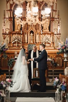 a bride and groom standing at the alter during their wedding ceremony