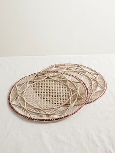 three woven trays sitting on top of a white table