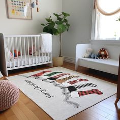 a baby's room with a white crib, rocking chair and large rug