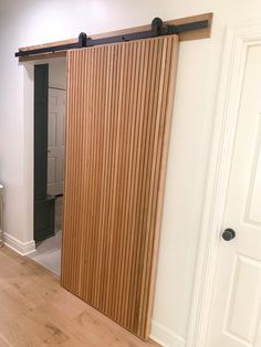 an empty room with a sliding door and hard wood flooring