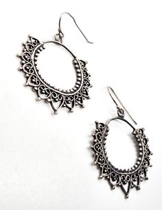 Mandala filigree sterling silver Indian silver drop hoop earrings. Good used condition with little to no signs of normal wear. Handmade soldering features. Beautiful patina. Acid tests positive for sterling silver. Earrings measure 1 and 3/4ths of an inch tall and 1 and 1/4 of an inch wide. Ornate Sterling Silver Hoop Earrings With Intricate Design, Silver Filigree Small Hoop Jewelry, Metal Hoop Earrings With Intricate Dangle Design, Sterling Silver Filigree Hoop Jewelry, Sterling Silver Drop Earrings For Festival, Silver Filigree Earrings For Festival, Elegant Oxidized Hoop Earrings For Festival, Ornate Nickel-free Round Hoop Earrings, Elegant Sterling Silver Hoop Earrings For Festival