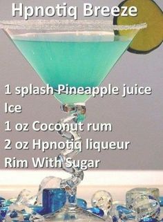 a blue and white drink with the ingredients labeled in it on top of ice cubes