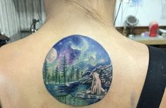 a woman with a tattoo on her back is looking at the night sky and stars