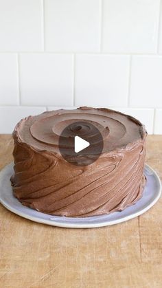 a chocolate cake sitting on top of a wooden table