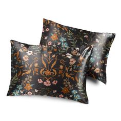 two pillows with floral designs on them, one is black and the other is orange