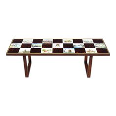 a coffee table made out of tile with wooden legs and a checkered design on the top