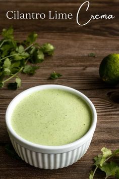 cilantro lime cream in a white bowl on a wooden table