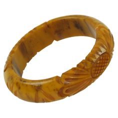 This stunning banana brown marble Bakelite carved bracelet bangle features a domed shape with deep floral carving, two designs on the bracelet, and a thick wall. The piece boasts an intense caramel yellow marbled tone with cloudy brown swirls, also called banana brown color. Measurements: Inside across is 2.57 in diameter (6.5 cm) - outside across is 3.32 in diameter (8.4 cm) - width is 0.75 in wide (1.9 cm) - wall is 0.38 in thick (1 cm). The inner circumference of the bracelet is 8.04 in (20.4 Thick Bracelets, Marbles For Sale, Amethyst Bangle, Bakelite Brooch, Bakelite Bracelets, Bakelite Jewelry, Brown Marble, French Jewelry, Antique Bracelets