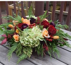 a bouquet of flowers sitting on top of a wooden table