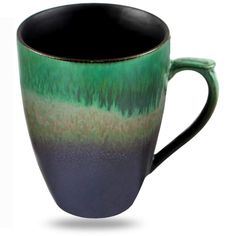 a black and green coffee cup with trees in the background