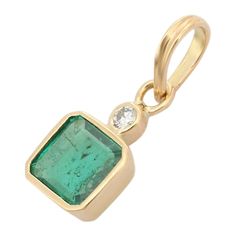 Everyday Emerald Diamond Pendant in 18K Gold studded with octagon cut emerald and round cut diamond. This stunning piece of jewelry instantly elevates a casual look or dressy outfit. Emerald enhances intellectual capacity of the person. Designed with octagon cut emerald set in center with a diamond set on top in solid gold making it a stunning everyday pendant. This is a perfect May Birthstone Pendant. The elegant style complements the attire beautifully and is a perfect Engagement Gift, Bridal Emerald Diamond Pendant, Everyday Pendant, Perfect Engagement Gifts, Emerald Necklace Pendant, Tanzanite Necklace, Diamond Pendant Sets, Emerald Pendant, Birthstone Pendant, Modern Necklaces