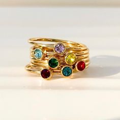 Give mom the gift of birthstone jewelry as a token of her love. Our birthstone rings were delicately designed to stack perfectly. Stack up to 5 rings together.  *SHIPS FAST in 1-3 business days* Band width: 1.2 mm  Stone size: 3 mm  Available in whole US sizes. 4 - 11  These rings are fitting true to size These are carefully made with 18k gold PVD coated stainless steel. This process vacuum seals the coating of 18K gold directly onto the steel producing a durable and tarnish-proof finish for years of wear. Additionally, stainless steel is hypoallergenic and won't turn your skin green. Gift Stackable Rings With Bezel Setting For May Birthstone, Stackable Bezel-set Rings For May Birthstone Gift, May Birthstone Stackable Rings With Bezel Setting, Gold Plated Birthstone Ring For Promise, Gold Stainless Steel Stackable Rings For Gift, Mother's Day 14k Gold Stackable Rings, Gold Plated Birthstone Rings As Gift, Dainty Gold Stackable Rings With Gemstones, Adjustable Gold Ring For May Birthstone