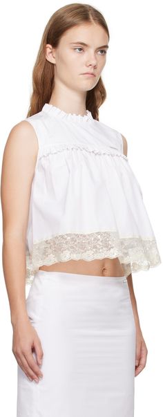 Cotton poplin blouse. Gathering and ruffled trim throughout. · Round neck · Logo hardware at chest · Sequinned lace trim at hem · Hook-eye fastening at back collar Supplier color: White Chic Tops With Lace Cuffs For Daywear, White Lace Tops With Scalloped Edges, Elegant Cotton Lace Top With Ruffles, Summer Tops With Lace Cuffs And Ruffled Collar, Chic Cotton Lace Top With Lace Collar, Daywear Lace Top With Lace Cuffs, Cotton Lace Top With Ruffles, Elegant Tops With Detachable Collar For Daywear, Spring Tops With Scalloped Edges For Daywear