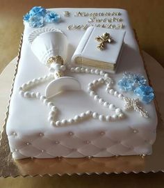 a cake that is decorated with pearls, beads, and books on top of it