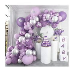 a bunch of balloons that are in the shape of flowers and butterflies on a table