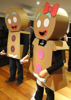 two people dressed up as gingerbread man and woman with cardboard boxes on their heads