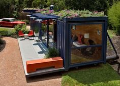 an outdoor living area with orange chairs and green roof