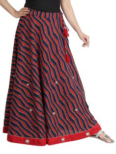 Smart Soft Cotton Stripes-Laharia Printed Red and Navy A Line Skirt with Smart ethnic work. Laharia print, Stripes Print. NON TRANSPARENT due to Full Cotton Inner lining. Ethnic Patch work of mirror and stones. Full 4.25 Meter botttom Round. Side open with Concealed zip. Drawstring of same fabric closure. Ethnic Tussers for elegant look. Definitely soft party wear.  Length of skirt 38 inches (96 cms), waist size available, 28,30,32,34,36,38,40. Other size on order please. Total weight of product 385 grams. Traditional Red Skirt With Traditional Patterns, Red Traditional Wear With Ikat Print For Navratri, Red Bohemian Traditional Wear In Cotton, Red Ikat Print Traditional Wear For Navratri, Bohemian Red Cotton Traditional Wear, Red Bohemian Cotton Traditional Wear, Traditional Red Skirt With Patterns, Traditional Ankle-length Skirt, Traditional Red Festive Skirt