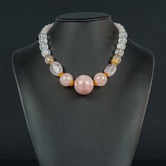 This 19 3/4" Rose Quartz necklace has a 30mm Bead in the center, framed by two 20mm beads followed by 14mm balls, gold-filled decorative end caps, and gold metal smooth rondels, reducing to 7mm balls in the back for less weight and easy wear. It closed with a fancy, round, flat 20mm toggle. Adjustable Rose Gold Necklace With Round Beads, Elegant Pink Beaded Necklaces With 8mm Beads, Elegant Pink Beaded Necklace With 8mm Beads, Rose Gold Single Strand Necklace With Round Beads, Rose Gold Jewelry With Round Rose Quartz Beads, Elegant Pink Necklaces With 8mm Beads, Elegant Rose Gold Necklaces With Gemstone Beads, Rose Quartz Necklace With Faceted Round Beads, Rose Quartz Faceted Beads Necklace