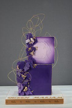 a purple box with flowers on it sitting on a table