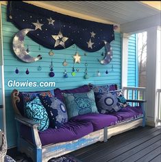 the porch is decorated with stars, moon and crescents hanging on the wall above the couch