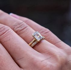 a woman's hand with a yellow and white diamond ring