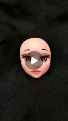 a close up of a doll's face on a black background