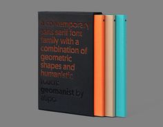 three books stacked on top of each other, one with an orange and blue cover