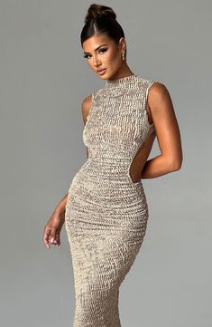 Crafted in our textured stretch fabric that hugs every curve, the Aphrodite midi features an asymmetric skirt with thigh high split. The high neck design is complete with a showstopping open back detail. Style yours with heeled mules and sleek waves. 



Colour: Beige.

Textured stretch fabric.



Open low back.

Asymmetric skirt.

Thigh high split.

Button closure at back neck.

High neck.

Midi length.

Model is an XS and is wearing an XS.

 Size: XS, S, M, L, XL, XXL