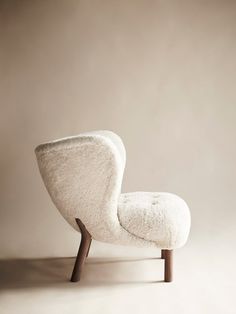 a white chair sitting on top of a wooden frame