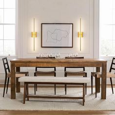 a dining room table with four chairs and a bench