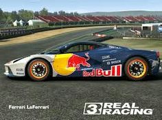 a red bull racing car on a race track with the words real racing written in front of it