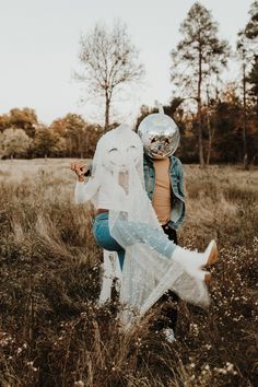 two people dressed up in costumes walking through a field