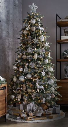 a decorated christmas tree with silver and white ornaments