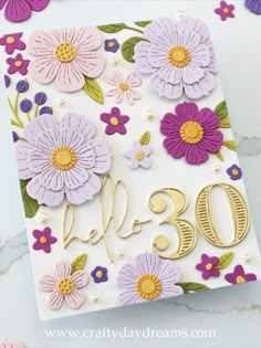 a birthday card with flowers and the number 30 on it, in gold lettering that says happy