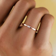 Minimalist Baguette Cut Solitaire Wedding Ring, Anniversary Stackable Emerald Cut Baguette Diamond Rings, Classic Stackable Wedding Rings With Baguette Diamonds, Modern Wedding Ring With Baguette Diamonds, Modern Baguette Diamond Ring For Wedding, Modern Wedding Diamond Ring With Baguette Diamonds, Modern Baguette Diamond Wedding Ring, Rose Gold Baguette Diamonds Wedding Ring, Emerald Cut Stackable Wedding Rings