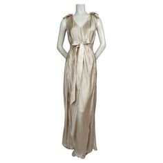 Champagne silk Grecian style wedding gown designed by Alber Elbaz for Lanvin dating to 2008. French size 36 however there is some flexibility in sizing due to the bias cut of the panels. Intentionally frayed edges. Net detail at top of shoulders. Long removable silk ribbon belt. Measurements are very difficult to accurately take because of the bias cut panels. Length is approximately 60". Fabric content: 100% silk. Button closure at back of neck. Made in France. Very good condition. Grecian Style Wedding Dress, Alber Elbaz, Grecian Style, Jeanne Lanvin, Maxi Gown Dress, Color Champagne, Style Wedding, Silk Ribbon, Lanvin