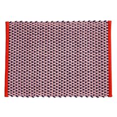 a pink and red place mat on a white surface