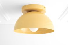 a yellow light fixture hanging from the ceiling