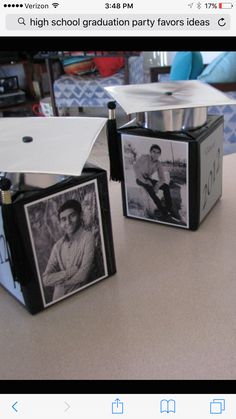 three small black and white photo frames on a table