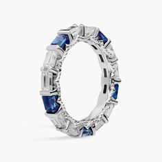 a white gold ring with blue sapphires and baguetts on the sides, set in