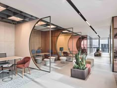 an office with glass partitions, chairs and desks in the middle of it