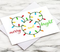 a christmas card with lights on it and merry and bright