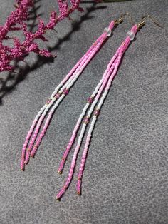 These pink Ombre tassel earrings have a frosted round bead at the top. The long slender design make them light weight to wear. They are made with high quality Japanese seed beads, small pink crystals with gold ear wire. 100% handmade with passion and attention to detail. Each piece can take hours to complete. Great to wear for any occasion and would make a good addition to your wardrobe. Would make a great gift for someone special. Fun to wear! Think Valentines! Please check out the many other listings in my shop! https://barbsbeadingstudio.etsy.com Handmade in the heart of Oklahoma, USA If you have any questions about this listing, please message me and I will be glad to help you. Thank you for visiting and happy shopping! Barbara Traditional Pink Beaded Earrings, Dangle Bead Earrings Diy, Pink Seed Bead Earrings, Beaded Fringe Earrings Pattern, Native American Beadwork Earrings, Pink Beaded Earrings, Beadwork Ideas, Native Earrings, Pink Tassel Earrings