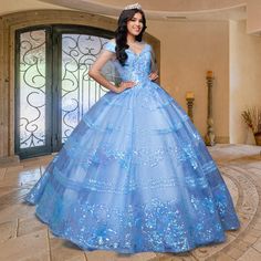 From the designers at QuinceGirl, this beautiful sequin quinceanera dress sparkles like sunshine in yellow or moonlight in blue. The off-the-shoulder quinceanera dress has sequin stripes and floral designs from the v-neckline to the hem. With regal flair, this traditional quince dress has a stylish fold-over collar with sparkly banded sleeves for an enchanting princess-inspired look. A back corset laces up for a comfortable fit on this fabulous sweetheart quinceanera gown, and layers of crinolin Sequin Ball Gown Quinceanera Dress, Fitted Sequin Quinceanera Dress, Sequined Quinceanera Dress For Prom Season, Sequined Quinceanera Dress For Debutante Ball, Sequin Quinceanera Dress For Debutante Ball And Prom, Quinceanera Dress With Sequins For Prom Season, Princess Quinceanera Dress With Sequins, Quinceanera Dress With Sequins And Fitted Bodice For Prom, Blue Quinceanera Dress For Sweet 16